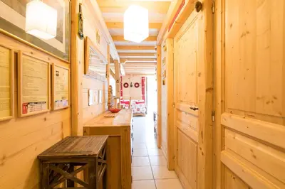a hallway with wooden walls and a wooden bench in a room at Comme un chalet, appartement à la montagne in Saint-Gervais-les-Bains