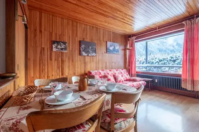 a dining room with a table and a couch at Apartment With Balcony Close To The Ski Slopes in Chamonix-Mont-Blanc
