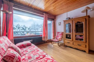 a living room with a couch and a large window at Apartment With Balcony Close To The Ski Slopes in Chamonix-Mont-Blanc