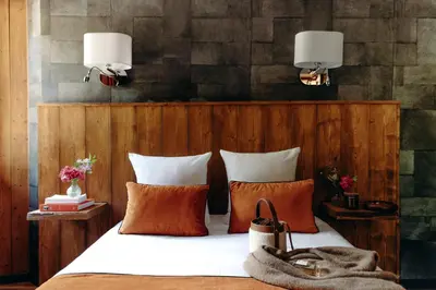 a bedroom with a bed with orange and white pillows at Auberge des Gorges - Restaurant Gastronomique & Chambres in Servoz