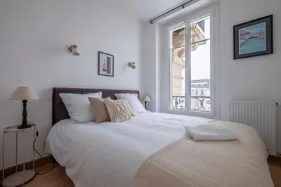 a bedroom with a large white bed with a window at Nice Apt With Balcony In Chamomix in Chamonix-Mont-Blanc