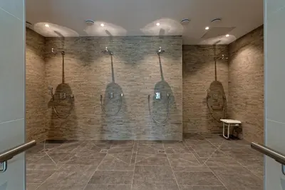 a bathroom with four sinks and mirrors on the wall at Résidence Club MMV Samoens Village in Samoëns