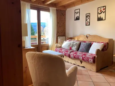 a bedroom with a bed and a chair and a window at Appartement sud chaleureux, proche centre et ski, WIFI - FR-1-624-14 in Samoëns