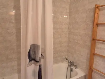 a bathroom with a shower curtain and a bath tub at Appartement sud chaleureux, proche centre et ski, WIFI - FR-1-624-14 in Samoëns