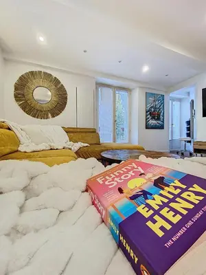 a book sitting on top of a bed in a room at Chamonix Hyper centre . terrasse vue mont blanc . parking in Chamonix-Mont-Blanc