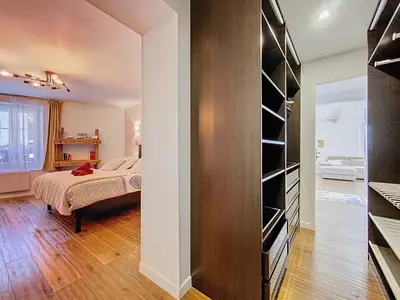a bedroom with a bed and a book shelf at Chamonix Hyper centre . terrasse vue mont blanc . parking in Chamonix-Mont-Blanc