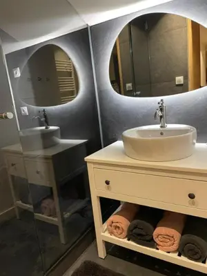 a bathroom with a sink and two mirrors at Kaban' des neiges in Saint-Gervais-les-Bains