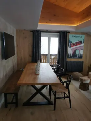 a wooden table and chairs in a living room at Kaban' des neiges in Saint-Gervais-les-Bains