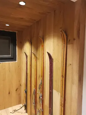 a bunch of skis are lined up on a wall at Kaban' des neiges in Saint-Gervais-les-Bains