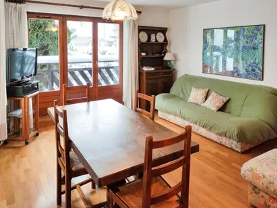 a living room with a table and a couch at Chemin du Sapi - Private Garden - Center of Cham - MontBlanc Views in Chamonix-Mont-Blanc