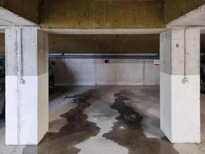 an empty parking garage with a car parked in it at Chemin du Sapi - Private Garden - Center of Cham - MontBlanc Views in Chamonix-Mont-Blanc