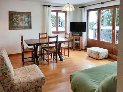a living room with a dining room table and chairs at Chemin du Sapi - Private Garden - Center of Cham - MontBlanc Views in Chamonix-Mont-Blanc