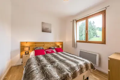 a living room with a couch and a table at L'Eden Ski aux Pieds in Morillon