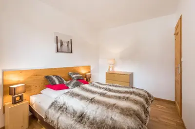 a living room with a table and a large window at L'Eden Ski aux Pieds in Morillon