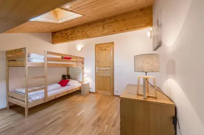 a living room with two couches and a table at L'Eden Ski aux Pieds in Morillon