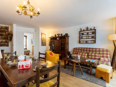 a dining room with a table and a fireplace at Apartment Le Beau Site by Interhome in Chamonix-Mont-Blanc
