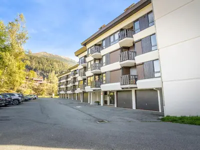 an empty parking lot in front of a building at Apartment Le Prarion by Interhome in Les Houches