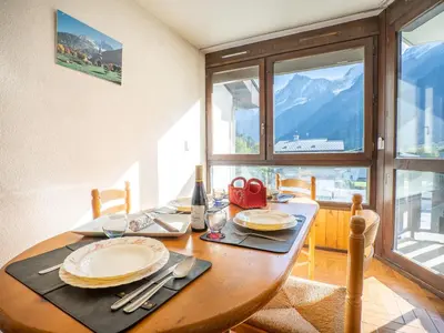 a dining room table with a view of the mountains at Apartment Le Prarion by Interhome in Les Houches