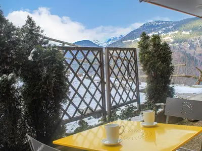 a yellow table and chairs on the patio of a house at Studio Rubis by Interhome in Saint-Gervais-les-Bains