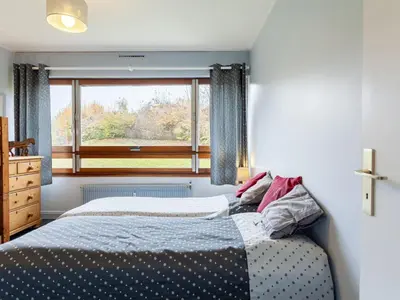 a bedroom with a bed in front of a window at Apartment Le Diorama-3 by Interhome in Saint-Gervais-les-Bains
