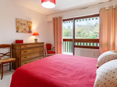 a bedroom with a red bed and a window at Apartment Le Diorama-3 by Interhome in Saint-Gervais-les-Bains