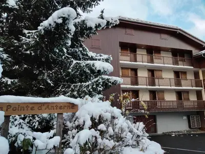 a building with a snow covered tree in front of it at Studio la Pointe d'Anterne by Interhome in Saint-Gervais-les-Bains