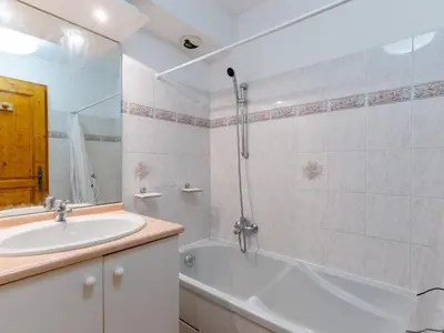 a bathroom with a tub and a sink and a shower at Apartment L'Espace Montagne-17 by Interhome in Chamonix-Mont-Blanc
