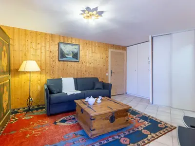 a living room with a couch and a coffee table at Apartment L'Espace Montagne-17 by Interhome in Chamonix-Mont-Blanc