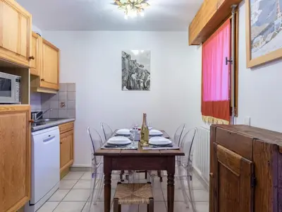 a kitchen with a table and chairs in a kitchen at Apartment L'Espace Montagne-17 by Interhome in Chamonix-Mont-Blanc