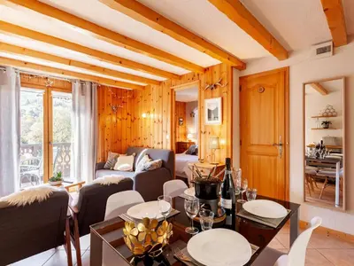 a living room with a couch and a tv at Apartment les Huskies-6 by Interhome in Saint-Gervais-les-Bains