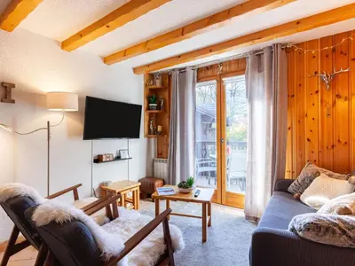 a bedroom with a large white bed and a mirror at Apartment les Huskies-6 by Interhome in Saint-Gervais-les-Bains