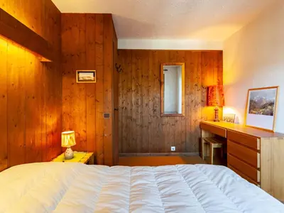 a bedroom with a large bed and a window at Apartment La Christaz by Interhome in Saint-Gervais-les-Bains