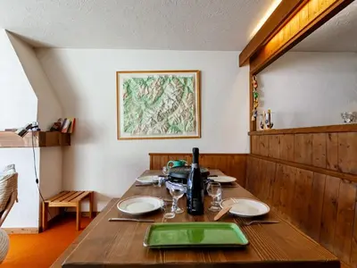 a kitchen with wooden cabinets and a white refrigerator at Apartment La Christaz by Interhome in Saint-Gervais-les-Bains