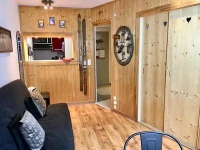 a living room with a couch and wooden walls at CHAMONIX CENTRE le Grepon in Chamonix-Mont-Blanc