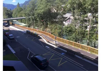 a highway with a bridge and a car on the road at CHAMONIX CENTRE le Grepon in Chamonix-Mont-Blanc