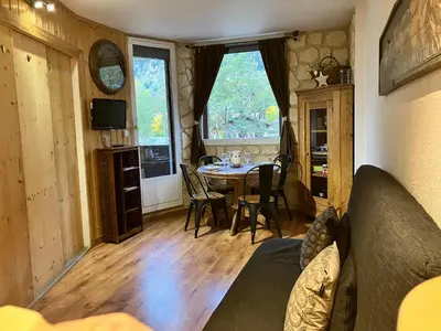 a living room with a table and a dining room at CHAMONIX CENTRE le Grepon in Chamonix-Mont-Blanc