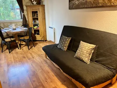 a living room with a couch and a table at CHAMONIX CENTRE le Grepon in Chamonix-Mont-Blanc