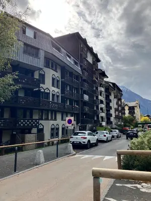 a street with cars parked in front of a building at CHAMONIX CENTRE le Grepon in Chamonix-Mont-Blanc