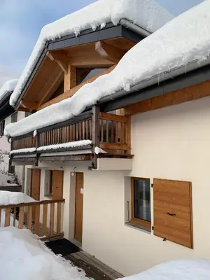 a living room with two couches and a coffee table at CHALET Mitoyen LE RUSTICANA in Chamonix-Mont-Blanc