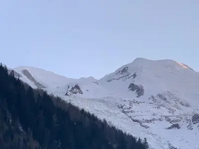 a living room with a couch and a table at CHALET Mitoyen LE RUSTICANA in Chamonix-Mont-Blanc