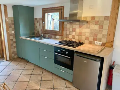 a kitchen with green cabinets and a stove top oven at Gorgeous Mini-Chalet Chamonix in Chamonix-Mont-Blanc