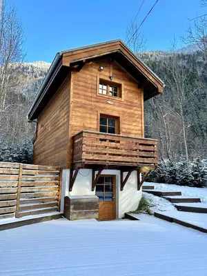 a large wooden house with snow on the ground at Gorgeous Mini-Chalet Chamonix in Chamonix-Mont-Blanc