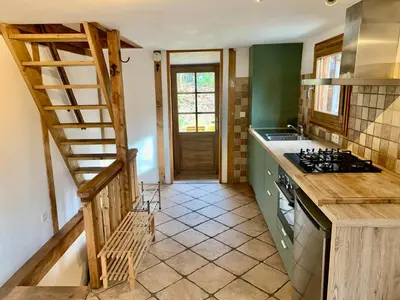 a kitchen with a staircase leading into a kitchen with a stove at Gorgeous Mini-Chalet Chamonix in Chamonix-Mont-Blanc