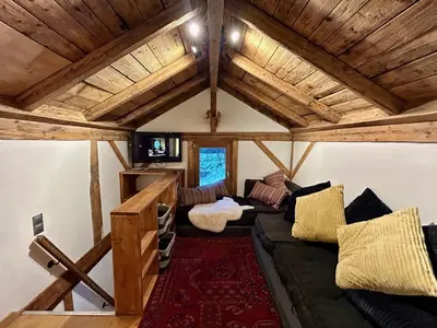 a living room with a couch and wooden ceilings at Gorgeous Mini-Chalet Chamonix in Chamonix-Mont-Blanc