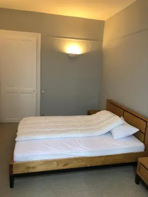 a bedroom with a large bed with white sheets at Little Mont Blanc - Saint Gervais in Saint-Gervais-les-Bains