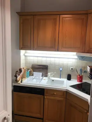 a kitchen with wooden cabinets and a sink at Little Mont Blanc - Saint Gervais in Saint-Gervais-les-Bains