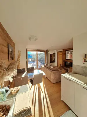 a living room with a couch and a table at appartement Shangrila in Chamonix-Mont-Blanc