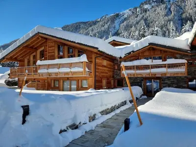 a log cabin in the snow with snow at appartement Shangrila in Chamonix-Mont-Blanc