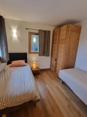 a bedroom with two beds and a window at appartement Shangrila in Chamonix-Mont-Blanc
