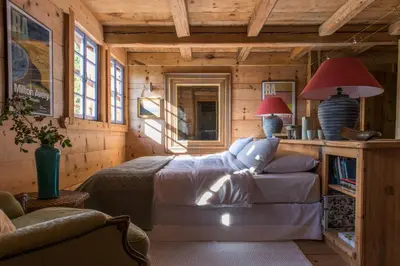 a bedroom with a bed in a wooden cabin at Arthaus Megève in Demi-Quartier